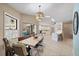 Dining room with modern light fixture, large windows, and flows into the kitchen at 7984 Glenbrooke Ln, Sarasota, FL 34243