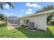 Home exterior showcasing the screened-in pool area, patio, and well-maintained yard at 7984 Glenbrooke Ln, Sarasota, FL 34243