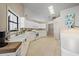 Bright kitchen with a breakfast bar, white cabinets, tile floor, and modern appliances at 7984 Glenbrooke Ln, Sarasota, FL 34243