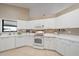 This kitchen has ample storage with white cabinets and drawers and standard appliances at 7984 Glenbrooke Ln, Sarasota, FL 34243