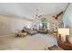 Open living room features a ceiling fan, neutral decor, and built in shelving at 7984 Glenbrooke Ln, Sarasota, FL 34243