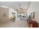 Bright living room with high ceilings, a ceiling fan, neutral tones, and sliding glass doors to an outdoor area at 7984 Glenbrooke Ln, Sarasota, FL 34243