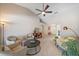 Bright living room with neutral tones, ceiling fan and lots of comfortable seating with view of the entryway at 7984 Glenbrooke Ln, Sarasota, FL 34243
