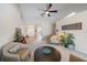 Bright living room with neutral tones, ceiling fan and lots of comfortable seating with view of the entryway at 7984 Glenbrooke Ln, Sarasota, FL 34243