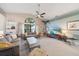 Bright living room with high ceilings, a large window, and comfortable seating at 7984 Glenbrooke Ln, Sarasota, FL 34243