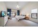 Spacious main bedroom with high ceilings, ceiling fan, natural light, and sliding door access to the outside at 7984 Glenbrooke Ln, Sarasota, FL 34243
