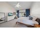 Bright main bedroom with a ceiling fan, sliding glass doors, and a view to the outside at 7984 Glenbrooke Ln, Sarasota, FL 34243