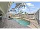 A beautiful screened in swimming pool is surrounded by brick pavers at 7984 Glenbrooke Ln, Sarasota, FL 34243