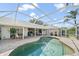 Inviting screened-in pool area with brick patio, perfect for outdoor entertaining and relaxation at 7984 Glenbrooke Ln, Sarasota, FL 34243
