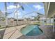 Relaxing screened-in pool area with brick patio and backyard views, creating a private oasis at 7984 Glenbrooke Ln, Sarasota, FL 34243