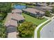 Aerial view of a well-maintained house with a lush lawn, landscaping, and waterfront view at 8191 Gabanna Dr, Sarasota, FL 34231