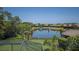 Scenic view of the backyard, pond, and surrounding community homes at 8191 Gabanna Dr, Sarasota, FL 34231