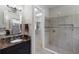 Bathroom showcasing a tiled shower with a glass enclosure and an entrance to a walk-in closet at 8191 Gabanna Dr, Sarasota, FL 34231