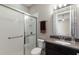 Bathroom featuring a tiled shower, granite vanity, and an adjacent toilet at 8191 Gabanna Dr, Sarasota, FL 34231