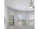 Bright bedroom with large windows and a modern ceiling fan at 8191 Gabanna Dr, Sarasota, FL 34231