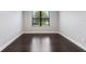 Bright bedroom with dark hardwood floors and a large window offering natural light at 8191 Gabanna Dr, Sarasota, FL 34231