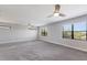 Large bedroom with gray carpet, recessed lighting, large windows, and ceiling fans at 8191 Gabanna Dr, Sarasota, FL 34231