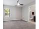 Neutral bedroom featuring plush carpet and ceiling fan with an ensuite bathroom at 8191 Gabanna Dr, Sarasota, FL 34231