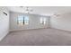 Spacious bedroom with gray carpet, ceiling fans, and two large windows for lots of natural light at 8191 Gabanna Dr, Sarasota, FL 34231