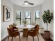 Cozy breakfast nook featuring a round table, four chairs, bay windows, and natural lighting at 8191 Gabanna Dr, Sarasota, FL 34231