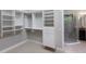 Walk-in closet with built-in shelving and drawers, located adjacent to the bathroom at 8191 Gabanna Dr, Sarasota, FL 34231
