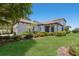 Beautiful well-maintained home featuring a lush lawn and landscaped garden beds at 8191 Gabanna Dr, Sarasota, FL 34231
