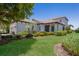 Well-maintained home with mature tree, lush lawn, and landscaped flower beds at 8191 Gabanna Dr, Sarasota, FL 34231