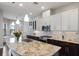 Open kitchen with stone countertops, modern appliances, breakfast bar and ample cabinet space at 8191 Gabanna Dr, Sarasota, FL 34231