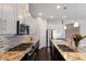 Modern kitchen featuring granite countertops, stainless steel appliances, and a gas cooktop at 8191 Gabanna Dr, Sarasota, FL 34231