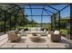 Relax in this screened-in lanai with beautiful views of the lake and surrounding landscape at 8191 Gabanna Dr, Sarasota, FL 34231
