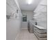 Laundry room with washer, dryer, wire racks, and storage bins for a functional space at 8191 Gabanna Dr, Sarasota, FL 34231