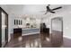 Spacious living room featuring hardwood floors, a modern ceiling fan, and an open layout to the kitchen at 8191 Gabanna Dr, Sarasota, FL 34231