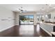 Open-concept living space with hardwood floors, slider doors to patio, and granite kitchen island at 8191 Gabanna Dr, Sarasota, FL 34231