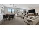 Open living space with two sofas, a media center, a game table, and plenty of natural light at 8191 Gabanna Dr, Sarasota, FL 34231