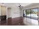 Open living space with slider doors to lanai, hardwood floors and dry bar at 8191 Gabanna Dr, Sarasota, FL 34231