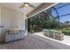 Relaxing screened in lanai featuring brick flooring, a grill, and comfortable furniture at 8191 Gabanna Dr, Sarasota, FL 34231