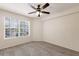 Bedroom with a neutral carpet, ceiling fan, and a large window at 850 S Tamiami Trl # 203, Sarasota, FL 34236