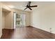 Bright bedroom with a ceiling fan, wood floors, and sliding glass doors to the balcony at 850 S Tamiami Trl # 203, Sarasota, FL 34236