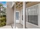 Exterior view of a condo unit with a covered porch and a door numbered 203 at 850 S Tamiami Trl # 203, Sarasota, FL 34236
