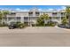 Attractive condominium complex with multiple units, stairways, and lush landscaping at 850 S Tamiami Trl # 203, Sarasota, FL 34236