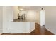 Kitchen with stainless appliances, granite countertops and dark, hardwood floors at 850 S Tamiami Trl # 203, Sarasota, FL 34236