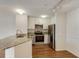 Bright kitchen with stainless steel appliances, granite countertops, and white cabinetry at 850 S Tamiami Trl # 203, Sarasota, FL 34236