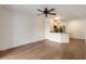 Open-concept living room featuring hardwood floors, a ceiling fan, and a view into the kitchen at 850 S Tamiami Trl # 203, Sarasota, FL 34236