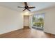 Well-lit living room with a ceiling fan, hardwood floors and access to an outdoor balcony at 850 S Tamiami Trl # 203, Sarasota, FL 34236