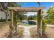 Picturesque view of a pond through a trellis, enhancing the natural beauty of the outdoor space at 850 S Tamiami Trl # 203, Sarasota, FL 34236