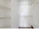 Bright, walk-in closet featuring white walls and metal shelving for optimal storage and organization at 850 S Tamiami Trl # 203, Sarasota, FL 34236