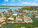 Overhead view features luxurious waterfront homes with private docks and boat lifts on a winding canal at 868 Siesta Key Cir, Sarasota, FL 34242