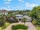 Aerial view of a single-Gathering home featuring mature landscaping and circular driveway in a beautiful neighborhood at 868 Siesta Key Cir, Sarasota, FL 34242