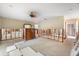 Bedroom shows walls stripped down to studs, ceiling fan, furniture, and no flooring at 868 Siesta Key Cir, Sarasota, FL 34242
