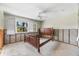 Bright bedroom featuring shuttered windows, ceiling fan, and a classic wood bed frame, ready for renovation at 868 Siesta Key Cir, Sarasota, FL 34242
